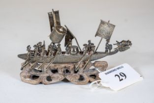 A Chinese white metal model of dragon boat, makers mark M.T. & character mark on a carved wooden