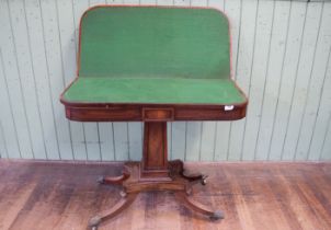 A Regency period mahogany ''D'' shaped card table, the ebony strung top above a panel centre frieze,