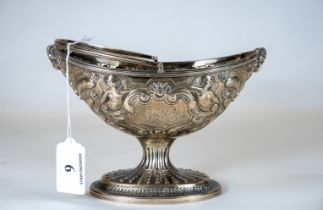 An Irish silver pedestal bowl, Dublin 1800, decorated with rams heads, cherubs and a swing handle,