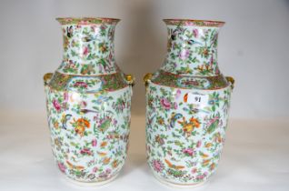 A Pair of 19th century Chinese cantonese porcelain vases each painted in typical palette with