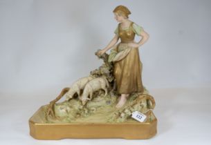 A late 19th century Austrian Royal Dux porcelain group depicting a female & two grazing sheep on