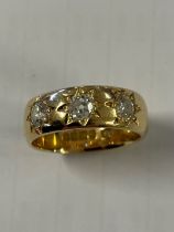 A Gents 18ct yellow gold band ring set with three diamonds, size S ½, full hallmark, approx. 10.