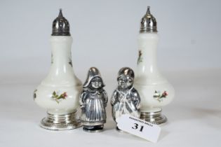 A pair of novelty white metal condiments in the form of Dutch Girl & Boy, each 7cms high and a