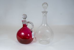 A Victorian cranberry glass decanter with twisted clear glass side handle & faceted stopper, 22cms