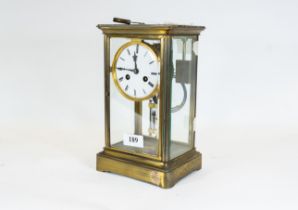 A late 19th/early 20th century French brass four-glass mantle clock, circular white enamel dial
