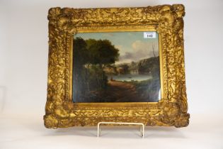A 19th century oil on canvas depicting a lakeside landscape with viaduct, boats & a figure,
