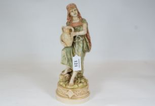A late 19th century Austrian Royal Dux porcelain figure of an Eastern Maiden holding an urn,