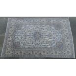 Carpet / Rug : A cream ground carpet with repeating trailing foliate decoration within a