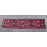 Carpet / Rug: A North West Persian Heriz Runner, the red ground with geometric motifs. Approx.