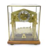 A 20thC brass Congreve / rolling ball style mantle clock in glass case. The case approx. 13 1/2"
