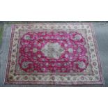Carpet / Rug : A North West Persian Tabriz carpet having a red ground with central cream medallion