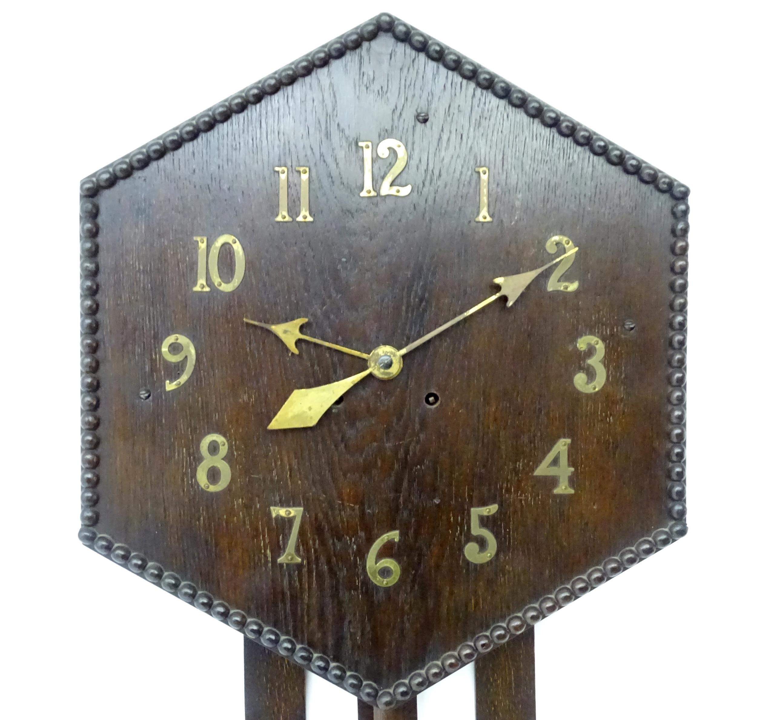 An Arts and Crafts style oak wall clock, the hexagonal dial with Arabic brass numerals and - Image 5 of 9