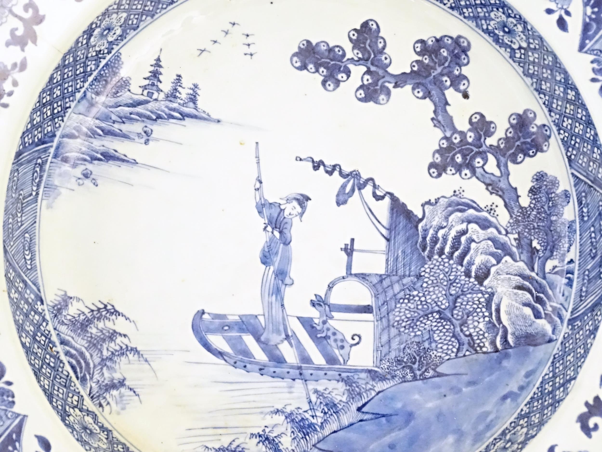 A Chinese blue and white bowl with shaped rim, decorated with a coastal scene with a figure and a - Image 2 of 8