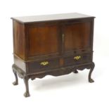 A 19thC Chippendale style cabinet, with a gadrooned rectangular top above two moulded and panelled