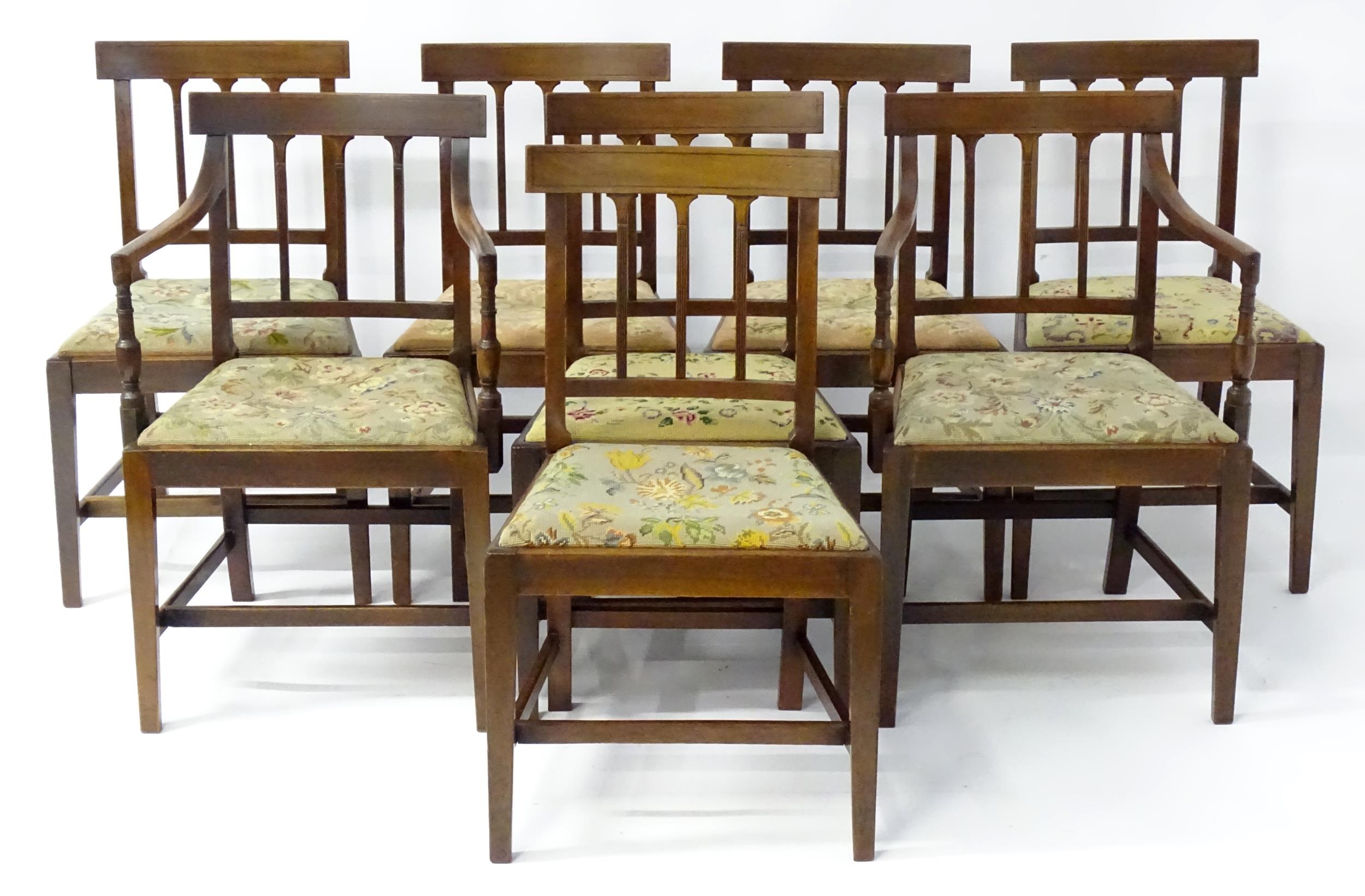 A set of eight Georgian mahogany dining chairs, having inlaid top rails above reeded back splats and