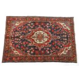 Carpet / Rug : A Central Persian Sarouk rug having a red, blue and cream ground with geometric