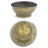 An Islamic brass bowl with embossed and engraved decoration depicting figures with weapons / arms,