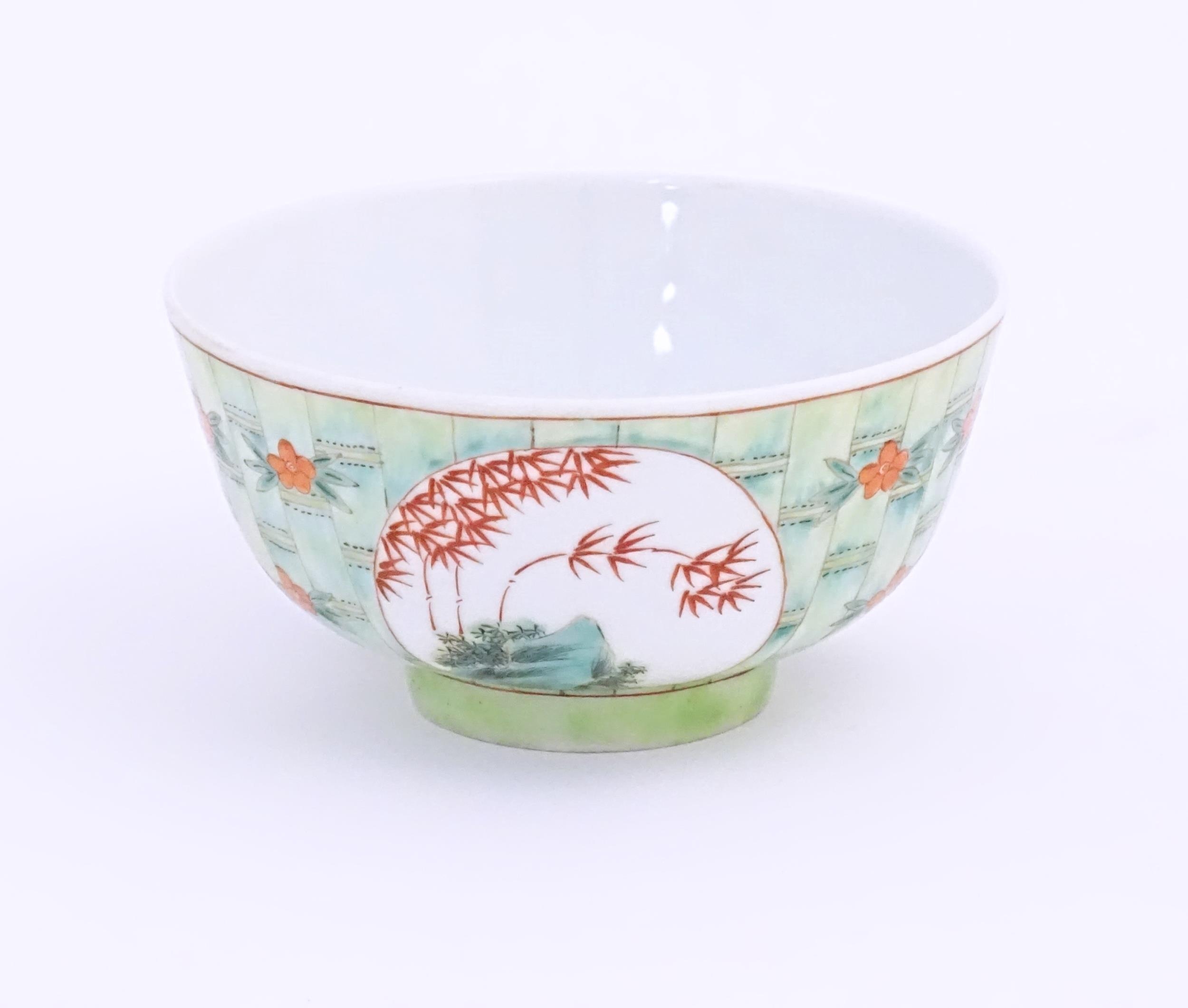 A small Chinese bowl decorated with stylised bamboo and flowers. Character marks under. Approx. 2