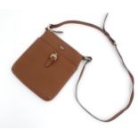 Vintage fashion / clothing: A Paul Costelloe leather cross body handbag in tan with buckle detail on