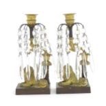 A pair of Continental early 20thC cast candle holders with lion detail to base and lustre drops.