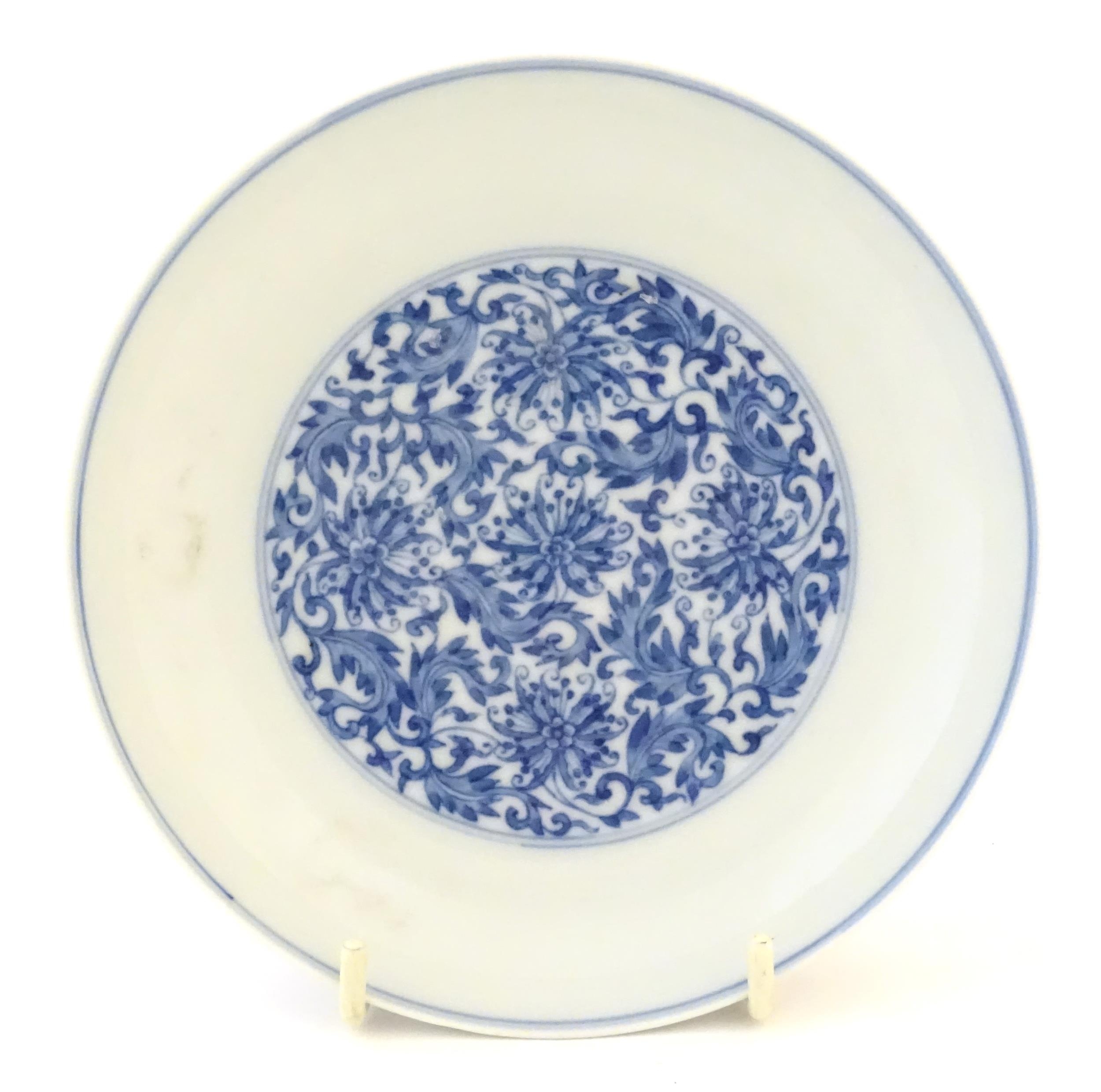 A Chinese blue and white plate decorated with scrolling floral and foliate detail. Character marks - Image 3 of 5