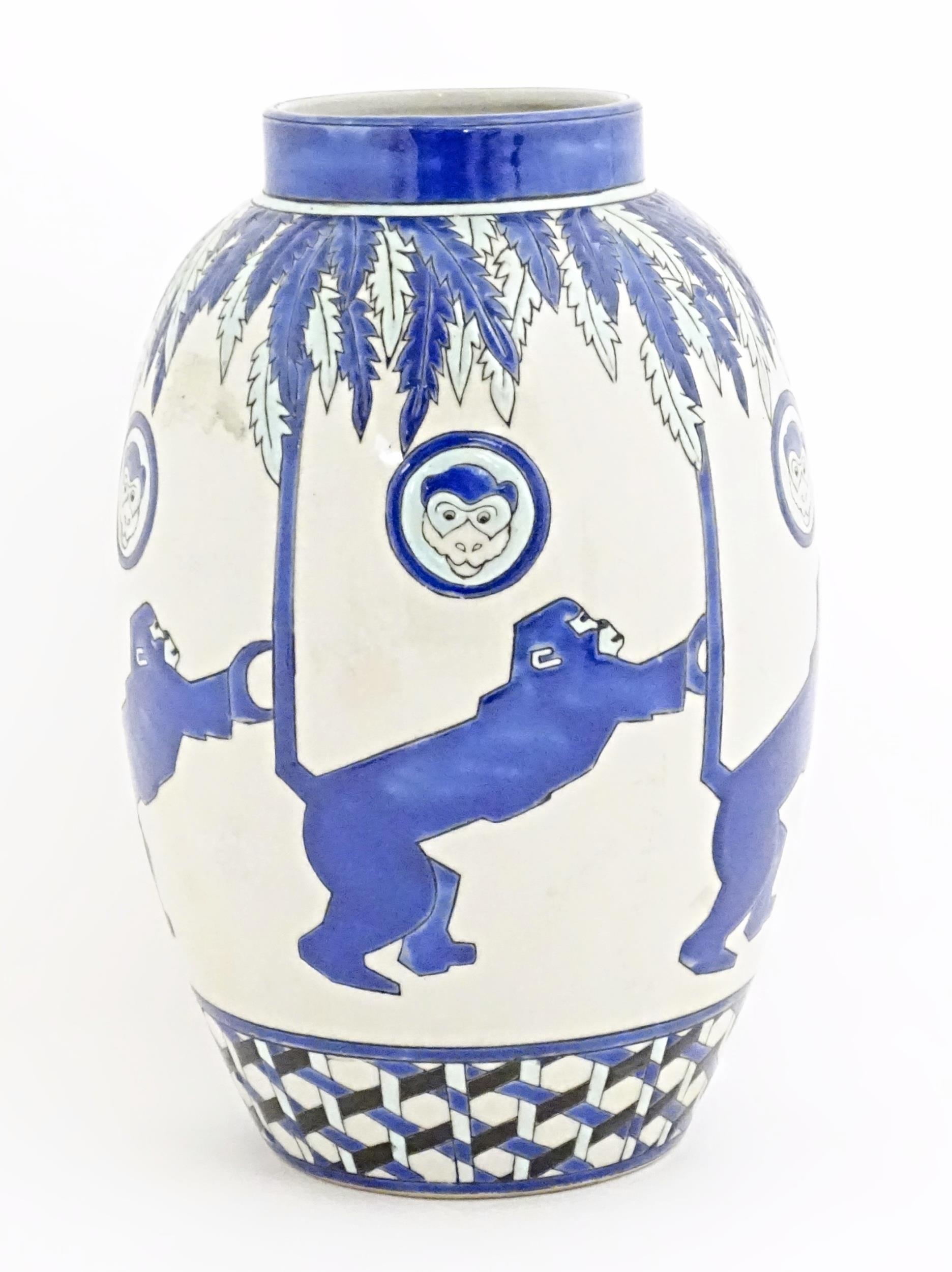 An Art Deco style blue and white vase decorated with banded monkey and palm tree detail. Marked - Image 5 of 8