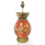 A terracotta table lamp with red, cream and gilt decoration. Approx. 15 1/2" high Please Note - we