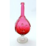 A 19thC red glass bottle vase with clear pedestal foot with stylised fleurs de lys detail and coiled