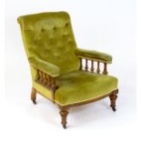 A late 19thC button back library chair with colonnade style turned support and raised on turned