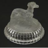 A frosted glass model of a greyhound dog upon a lid formed base. Approx 2 1/2" high Please Note - we