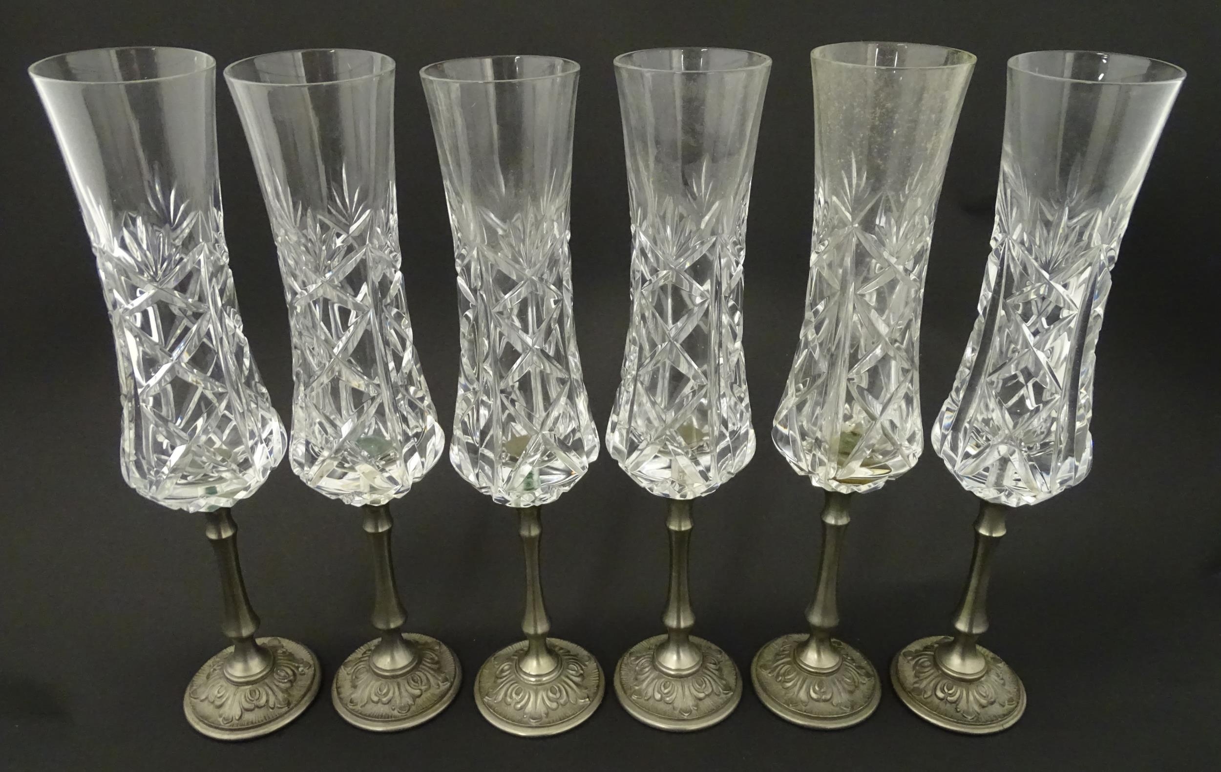 A set of six Italian cut glass champagne flutes raised on pewter stem and foot. Approx 11" high (