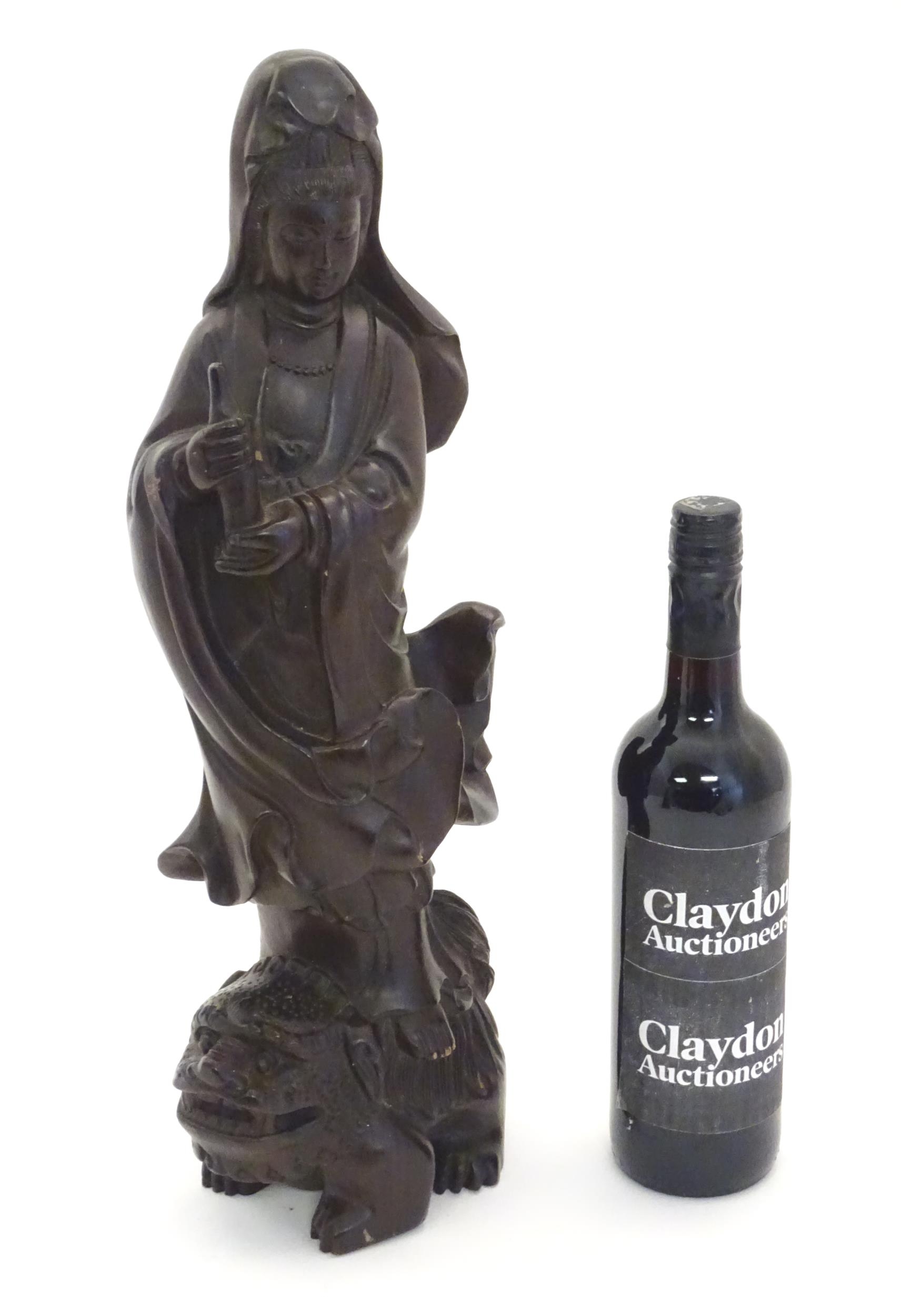 A Chinese carved hardwood model of Guanyin, Bodhisattva of Compassion, holding a bottle and standing