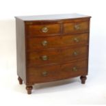 A 19thC mahogany bow fronted chest of drawers comprising two short over three long drawers raised on