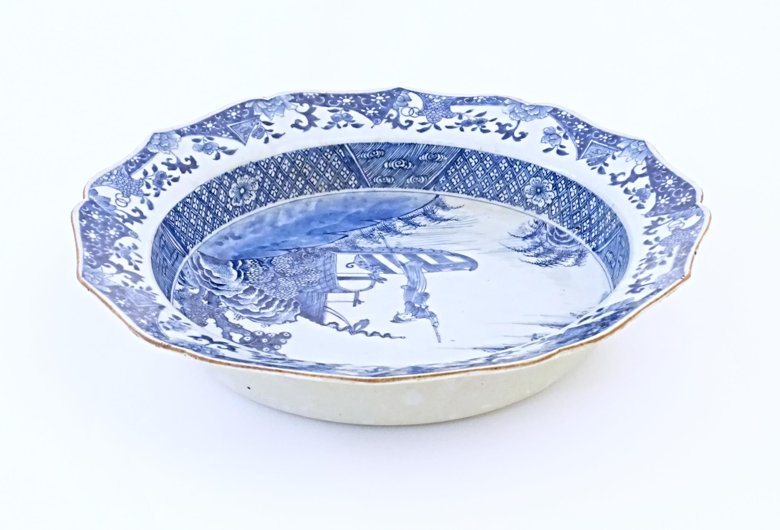 A Chinese blue and white bowl with shaped rim, decorated with a coastal scene with a figure and a - Image 7 of 8