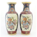 A pair of large Oriental vases decorated with panelled decoration depicting birds, flowers and