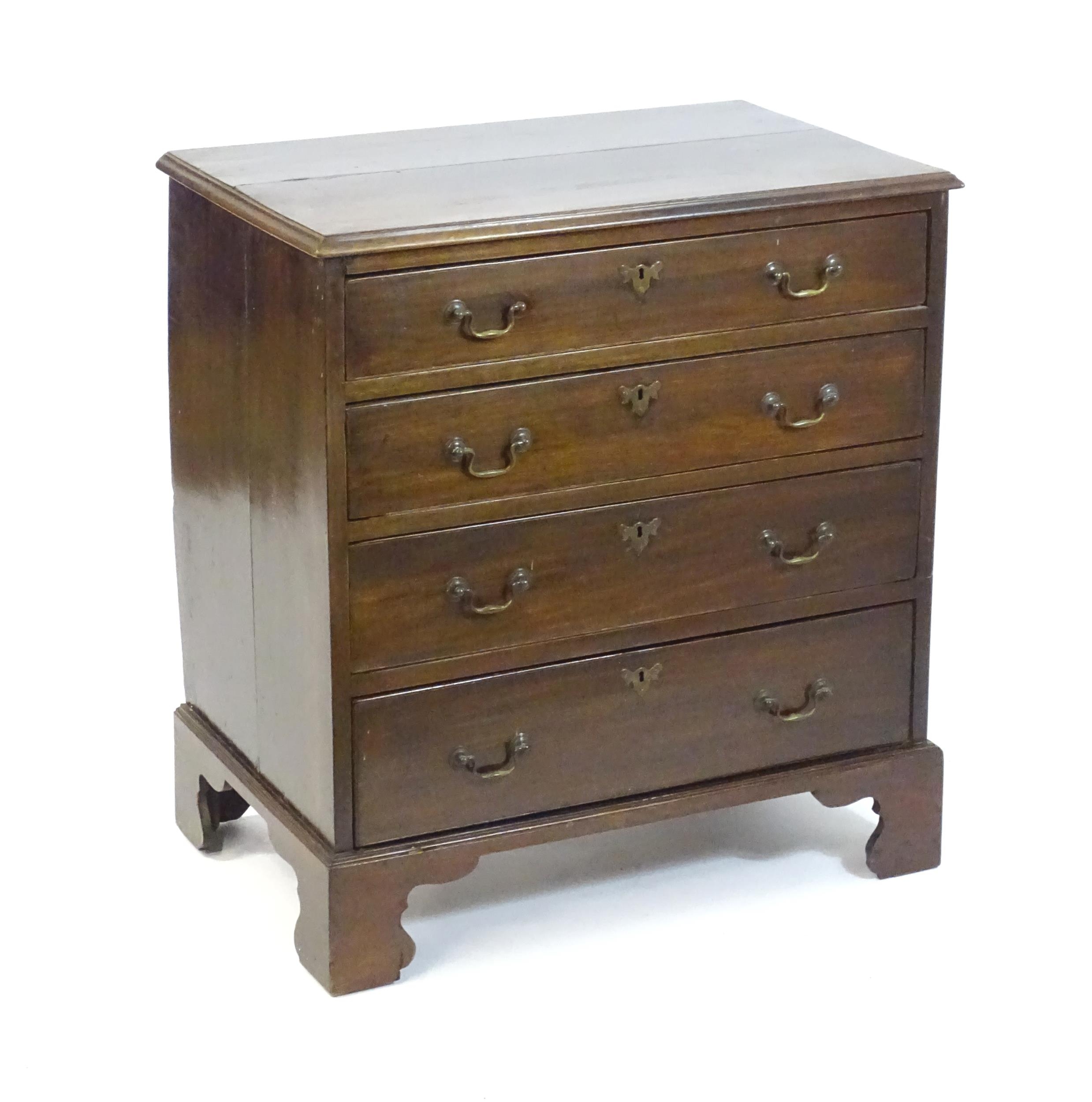 A late Georgian mahogany chest of drawers, having a rectangular moulded top above four long