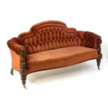 A 19thC mahogany sofa with deep buttoned upholstery and a carved frame, having gadrooned finials and