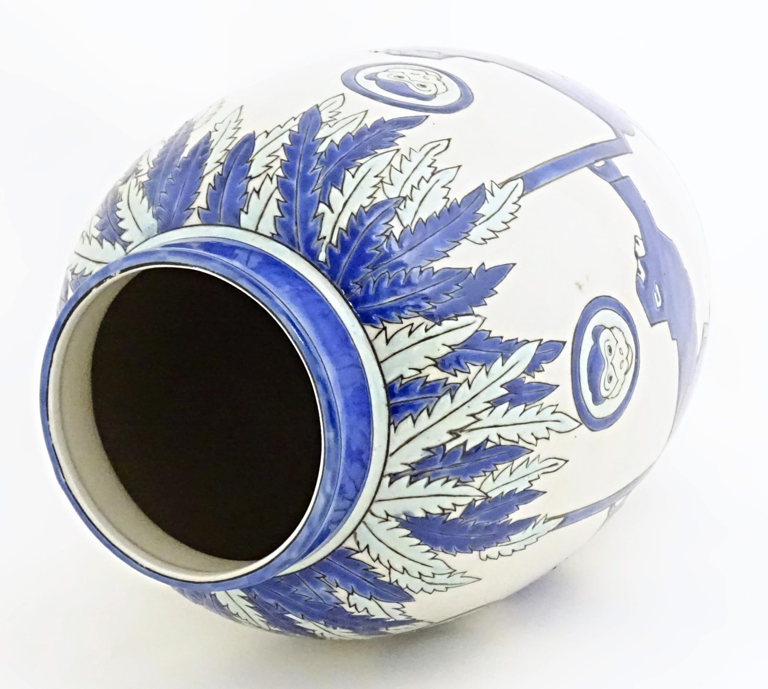 An Art Deco style blue and white vase decorated with banded monkey and palm tree detail. Marked - Image 7 of 8