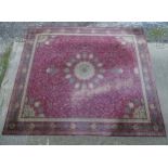 Carpet / Rug : A red ground carpet with repeating trailing foliate decoration within a