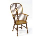 A 19thC Windsor chair with a double bow back and heart shaped motifs to the back splat, the chair