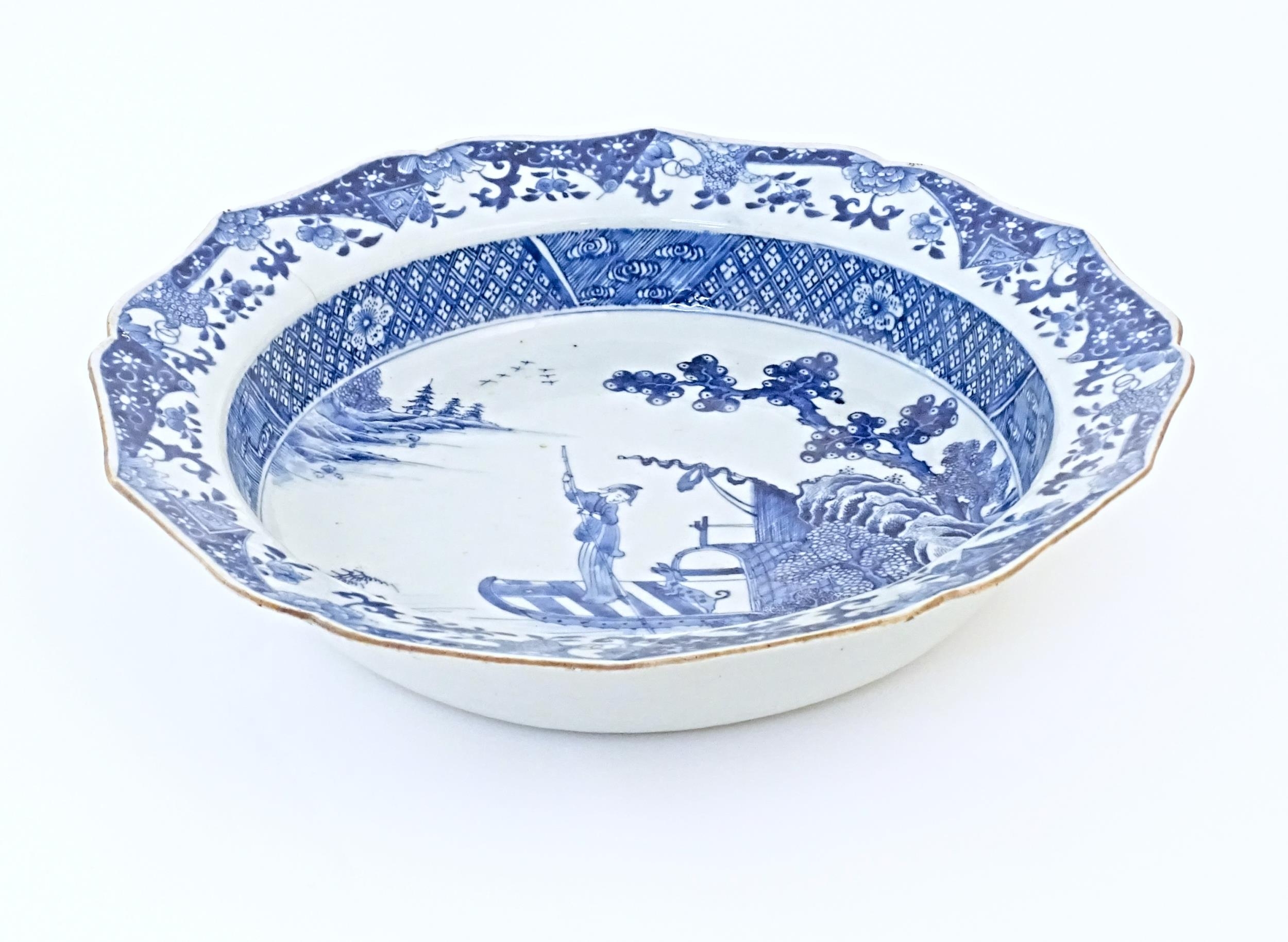 A Chinese blue and white bowl with shaped rim, decorated with a coastal scene with a figure and a - Image 5 of 8