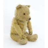Toy: A 20thC mohair teddy bear with stitched nose, mouth and paws. Approx. 19 1/2" long Please