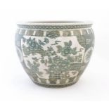 A Chinese famille verte jardiniere / planter decorated with flowers and foliage, with banded