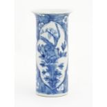 A Chinese blue and white vase of cylindrical form with a flared rim, decorated with birds, flowers