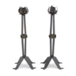 A pair of Arts & Crafts style wrought iron lamps with foliate detail to top and brass rosette detail