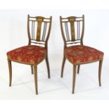 A pair of rosewood side chairs with marquetry inlaid classical and floral decorations, the chairs
