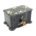 A Victorian papier mache tea caddy with inlaid abalone decoration, opening to reveal two lidded
