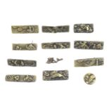 A quantity of Japanese brass menuki to include examples depicting warriors, birds, flowers, etc.