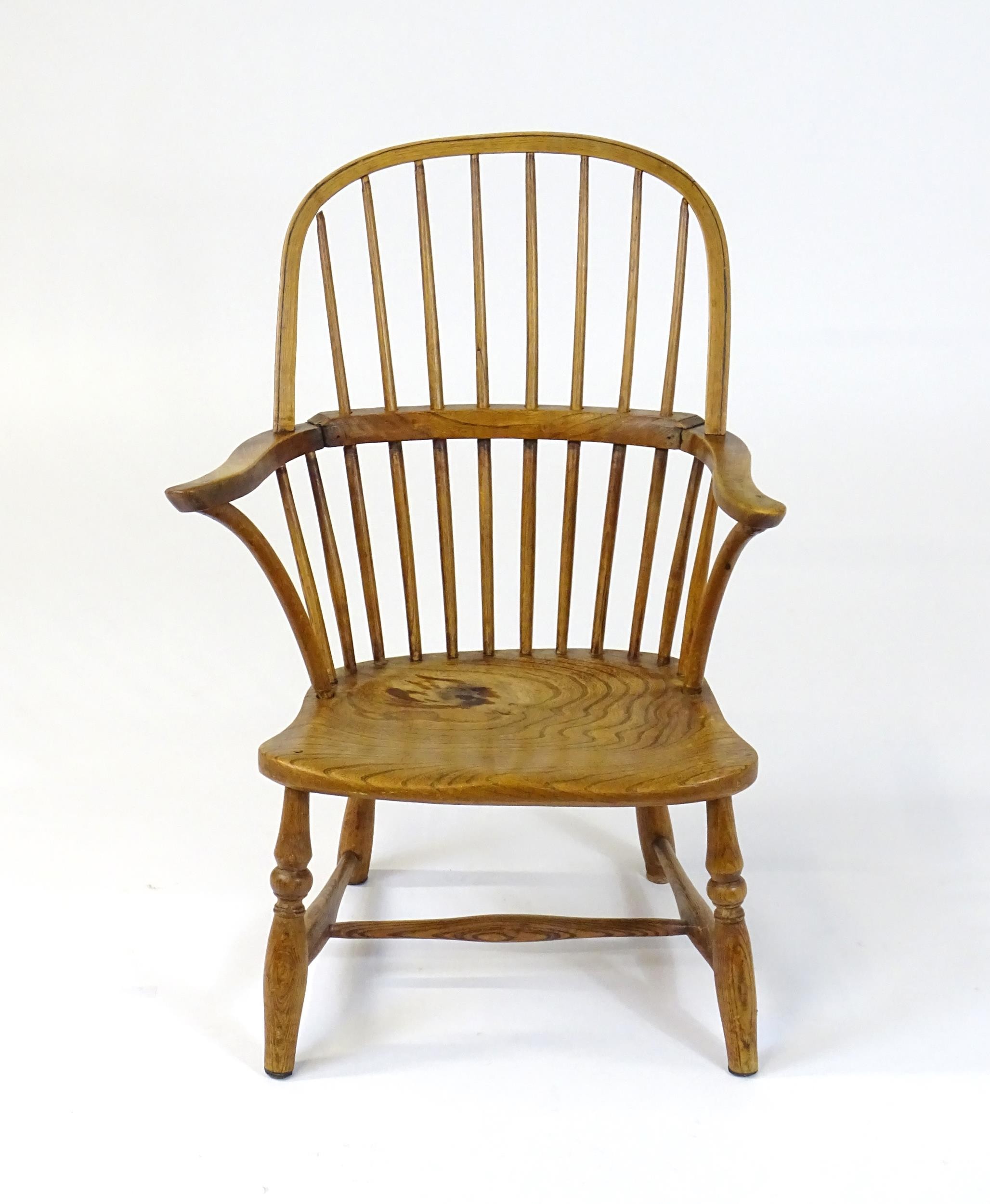 An early / mid 19thC Windsor chair of ash, elm and beech construction, having a double bow back,