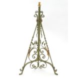 An Arts & Crafts wrought iron and copper telescopic lamp stand, the triform base with painted finish